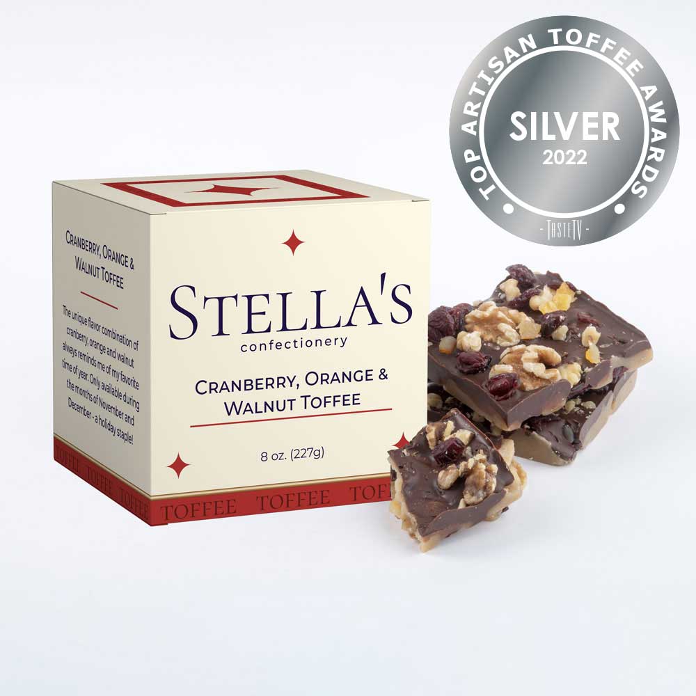Box of Cranberry, Orange and Walnut toffee next to toffee pieces and a silver award badge