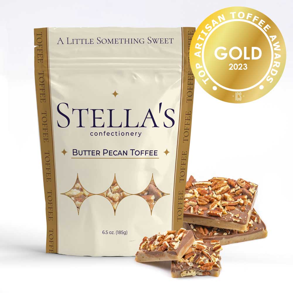 Stand up pouch of Butter Pecan toffee next to toffee pieces and a gold award badge