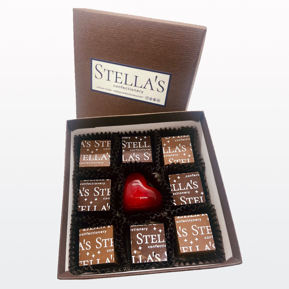A box of 9 milk and dark chocolate sea salt caramels with a red heart in the middle